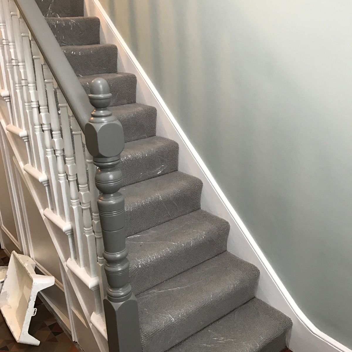 Stairway and banisters after painting (carpet protector still in place)